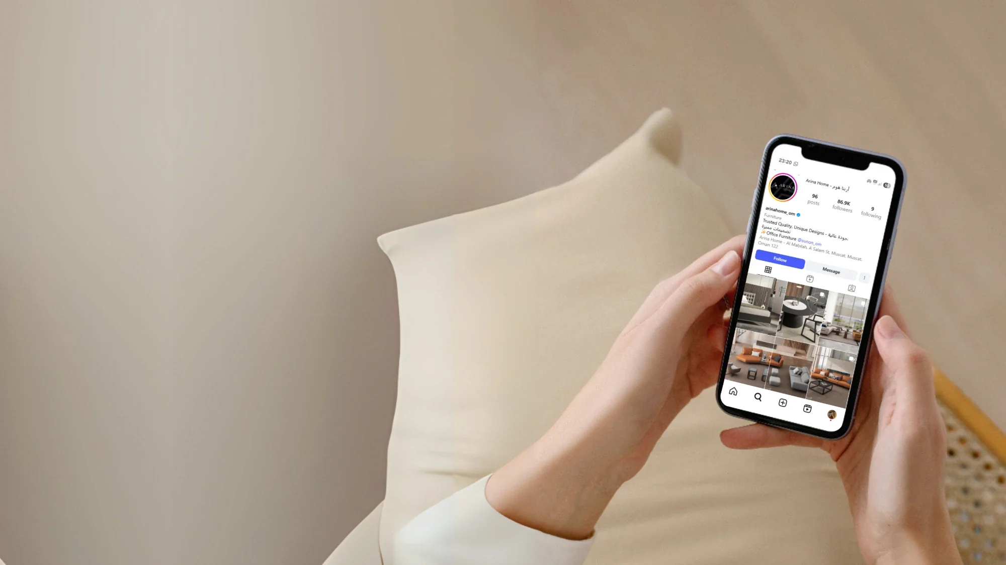 A hand holding a phone showing the Arina Home Instagram feed