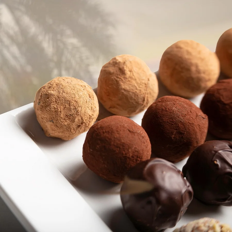 Cocoa-dusted date truffles in soft light